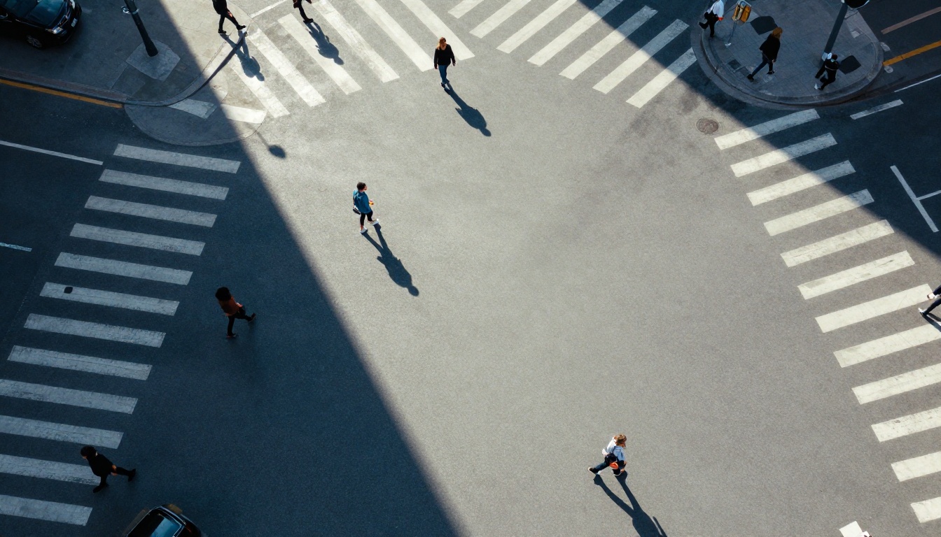 Aerial bird's-eye view of an urban pedestrian intersection with geometric morning shadows Aerial bird's-eye view of an urban pedestrian intersection with geometric morning shadows