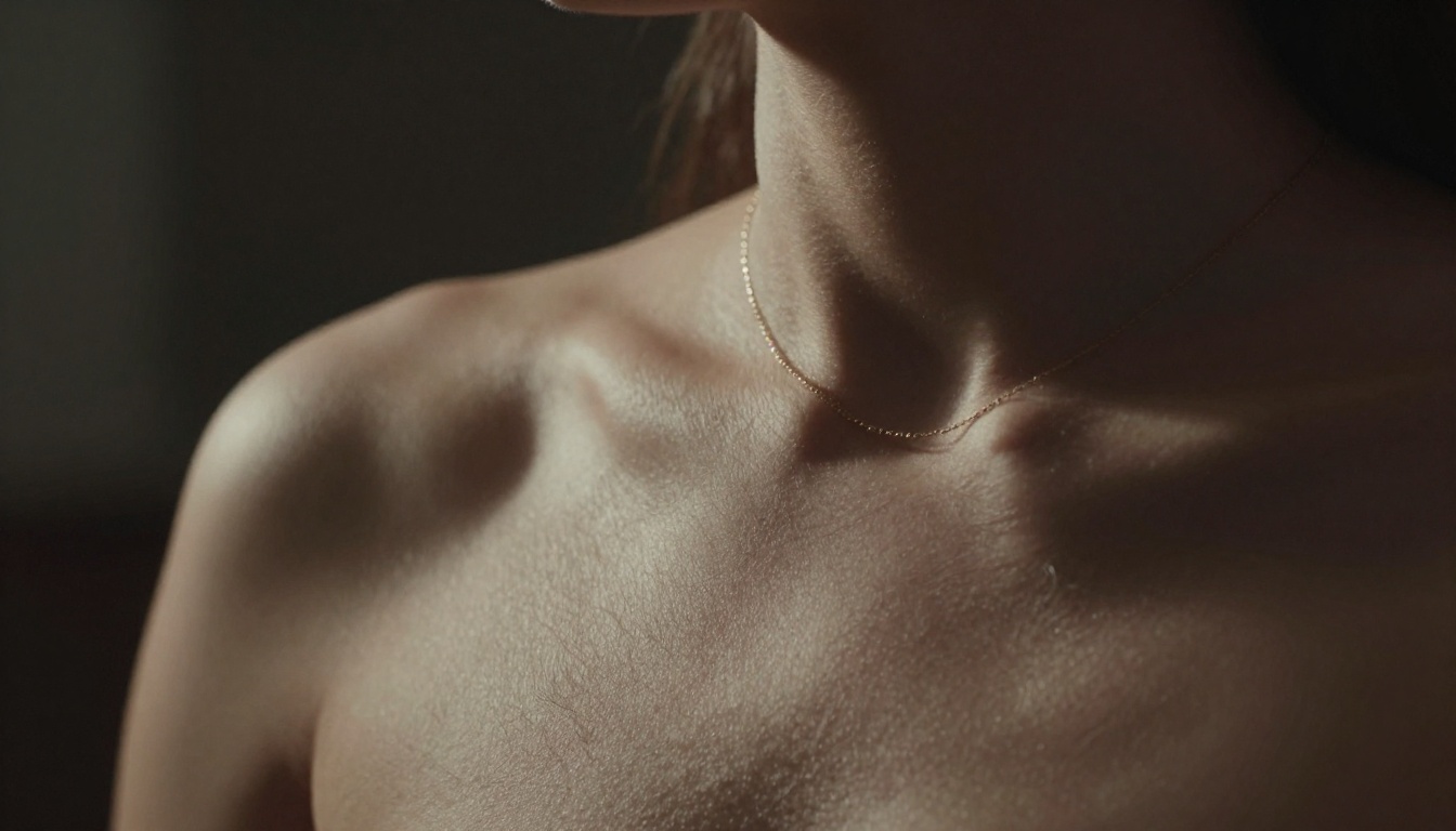 Dramatic chiaroscuro close-up, shoulder and neck detail, fine art photography